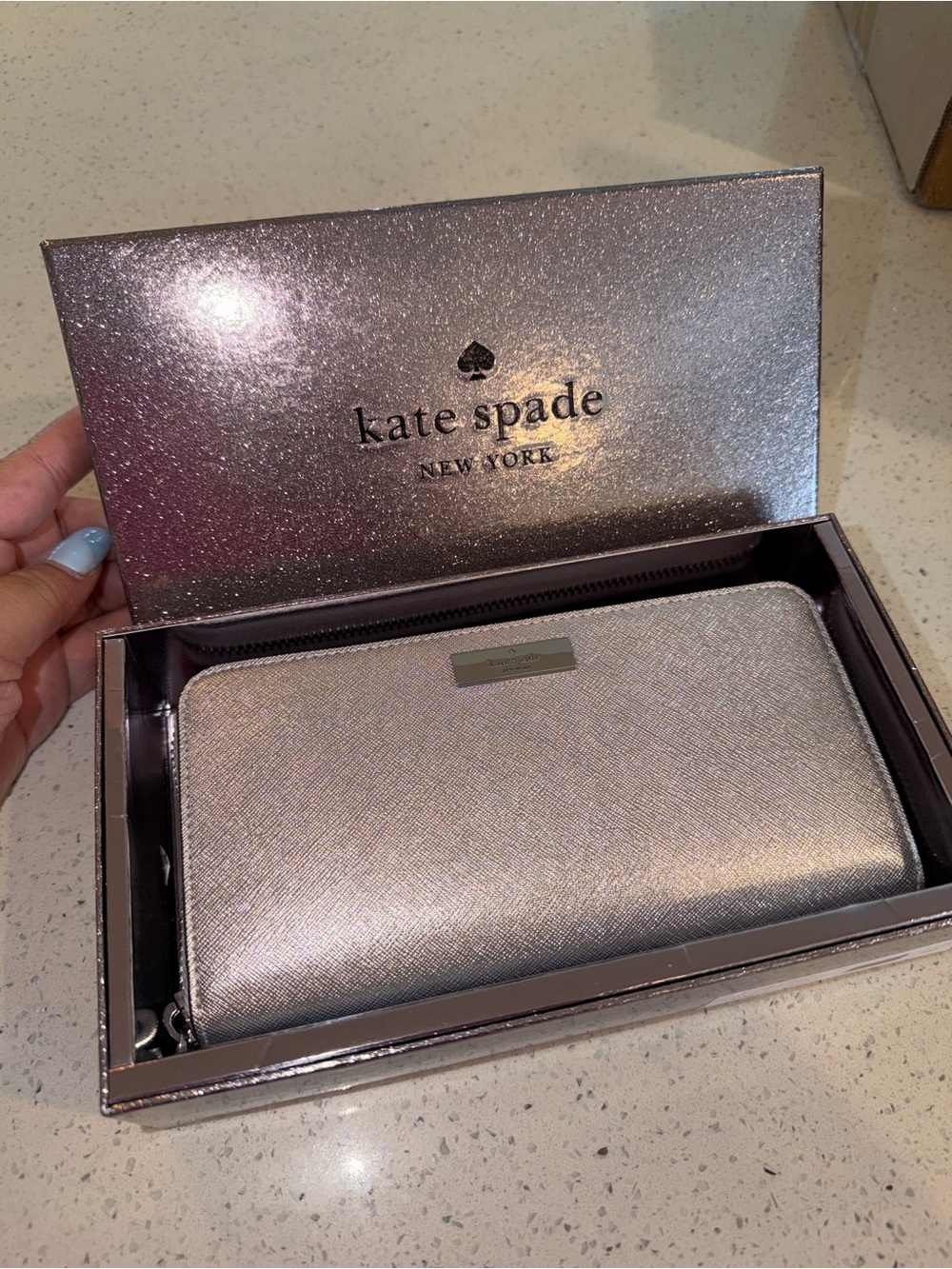 Kate Spade New York Kenzie Glitter Zip Wallet, featured in metallic silver.